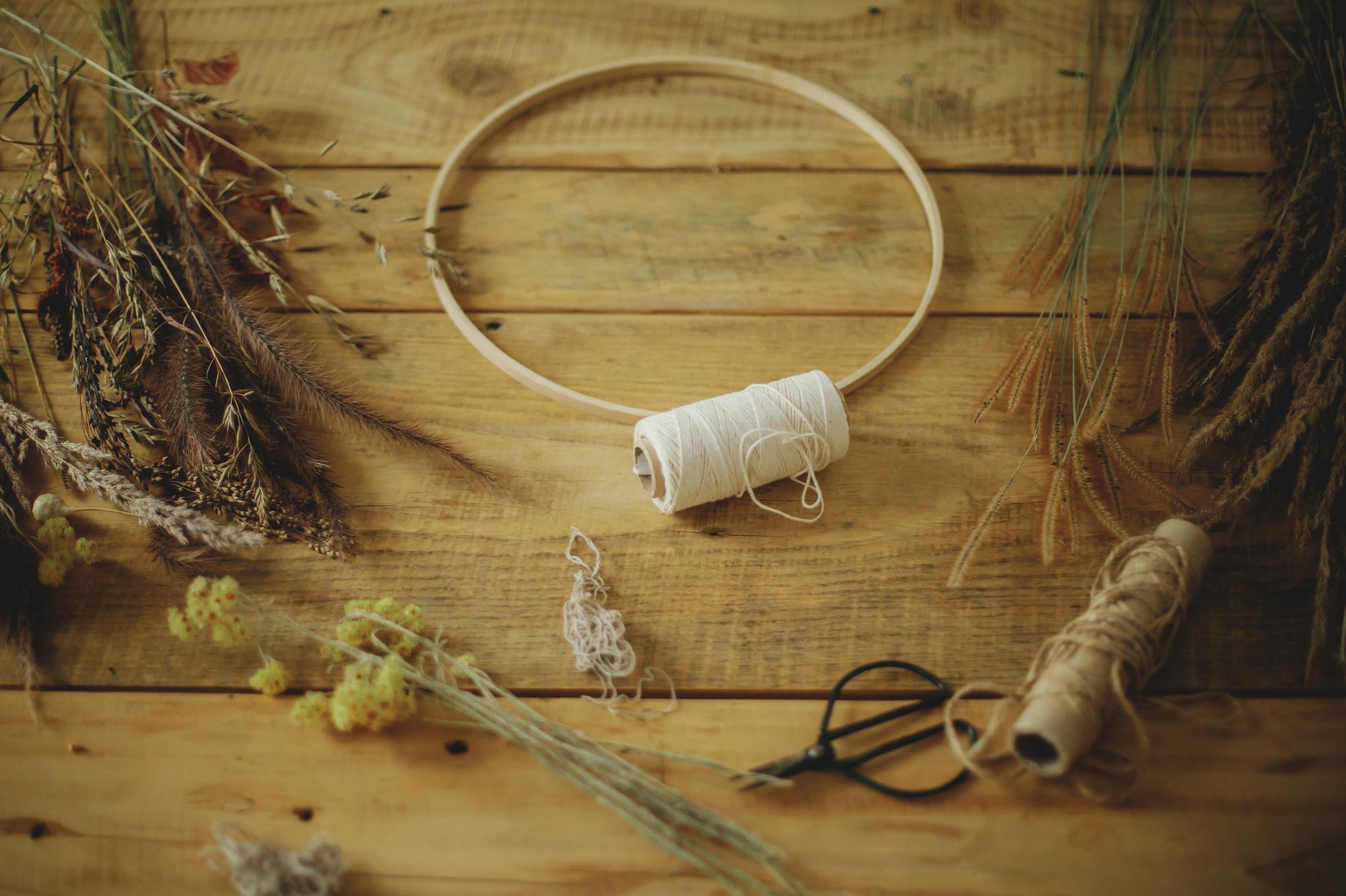 Studio workspace with embroidery hoops and threads